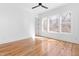 Light-filled bedroom with hardwood floors, large windows, and a modern ceiling fan at 149 Bonica Creek Dr, Garner, NC 27529