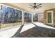 Stone patio with ceiling fan features iron railing and wooded backyard views at 149 Bonica Creek Dr, Garner, NC 27529
