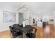 Dining room featuring a black dining table, modern lighting fixture, and view of the modern kitchen at 149 Bonica Creek Dr, Garner, NC 27529