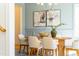 Bright dining room with modern chandelier, oval table with six chairs, and decorative art at 149 Bonica Creek Dr, Garner, NC 27529