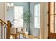 Cozy dining room featuring a round wooden table, cushioned chairs, chandelier, and wainscoting, creating an inviting space at 149 Bonica Creek Dr, Garner, NC 27529