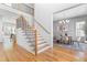 Inviting home foyer with hardwood floors, a staircase, and a view of the dining room at 149 Bonica Creek Dr, Garner, NC 27529