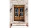 Elegant solid wood double front door with glass panes, sidelights, and decorative hardware at 149 Bonica Creek Dr, Garner, NC 27529