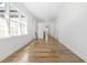 Hallway featuring hardwood floors and a view of windows and doors at 149 Bonica Creek Dr, Garner, NC 27529