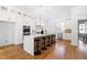 Charming kitchen island with barstool seating, stone countertops, and modern appliances at 149 Bonica Creek Dr, Garner, NC 27529