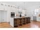 Bright kitchen with a large island, white cabinets and stainless steel appliances at 149 Bonica Creek Dr, Garner, NC 27529