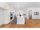 Gorgeous kitchen featuring a large island, white cabinets and an elegant pendant light at 149 Bonica Creek Dr, Garner, NC 27529
