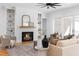 Living room featuring a cozy fireplace with mantle and built-in shelving for storage and decor at 149 Bonica Creek Dr, Garner, NC 27529
