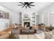 Bright living room with a ceiling fan, fireplace, custom shelving, and plenty of comfortable seating at 149 Bonica Creek Dr, Garner, NC 27529