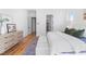 Serene primary bedroom showcasing wood floors, ensuite access, and a dresser at 149 Bonica Creek Dr, Garner, NC 27529