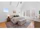 Spacious primary bedroom with vaulted ceiling, large windows, and a cozy sitting area at 149 Bonica Creek Dr, Garner, NC 27529