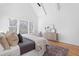 Bright primary bedroom with a vaulted ceiling, large windows, and hardwood flooring at 149 Bonica Creek Dr, Garner, NC 27529