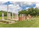 Outdoor monument with informational stone pillars, benches, and an American flag in a grassy park area at 149 Bonica Creek Dr, Garner, NC 27529