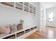 Charming mudroom with built-in bench seating, ample storage baskets, and hardwood floors at 149 Bonica Creek Dr, Garner, NC 27529