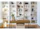 Custom office with built-in shelving, contemporary decor, and a large desk at 149 Bonica Creek Dr, Garner, NC 27529