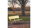 A cozy wooden park bench invites relaxation amidst the natural beauty of a serene park setting at 149 Bonica Creek Dr, Garner, NC 27529