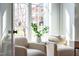 Cozy sitting area with lots of light, modern chairs and stylish decor with greenery at 149 Bonica Creek Dr, Garner, NC 27529
