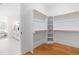 Spacious walk-in closet with built-in shelving and wooden floors, offering ample storage space at 149 Bonica Creek Dr, Garner, NC 27529