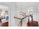 Hallway features a wood staircase, a modern light fixture, and views into other rooms at 1530 The Preserve Trail, Chapel Hill, NC 27517