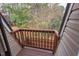 A wooden balcony overlooks mature trees offering a private outdoor space at 159 Finley Forest Dr, Chapel Hill, NC 27517
