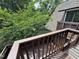 A view from the balcony of the exterior of the home shows surrounding trees at 159 Finley Forest Dr, Chapel Hill, NC 27517