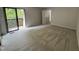 Bright bedroom features sliding glass doors to a private balcony and neutral carpeting at 159 Finley Forest Dr, Chapel Hill, NC 27517