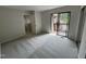 Bedroom features neutral paint, balcony access, and a view into an attached bathroom and closet at 159 Finley Forest Dr, Chapel Hill, NC 27517