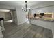 An open concept living/dining area features modern flooring and a pass-through to the kitchen at 159 Finley Forest Dr, Chapel Hill, NC 27517