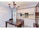 Inviting dining area with modern chandelier and kitchen view at 159 Finley Forest Dr, Chapel Hill, NC 27517