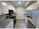 Galley kitchen features granite counters, white cabinets, and stainless appliances at 159 Finley Forest Dr, Chapel Hill, NC 27517