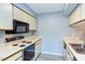 Functional kitchen featuring a range, microwave, and ample cabinet space at 159 Finley Forest Dr, Chapel Hill, NC 27517