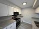 Kitchen features granite counters, stainless appliances and sleek white cabinets at 159 Finley Forest Dr, Chapel Hill, NC 27517