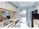 Bright kitchen with a view to an outdoor living space and stairs to a lower level at 159 Finley Forest Dr, Chapel Hill, NC 27517