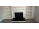 Living room with a fireplace and built-in bookshelves features modern flooring at 159 Finley Forest Dr, Chapel Hill, NC 27517