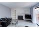 Cozy living room with a fireplace, built-in shelving, and natural light at 159 Finley Forest Dr, Chapel Hill, NC 27517