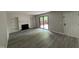 Cozy living room features a fireplace with built-in bookshelves, and sliding glass doors to a deck at 159 Finley Forest Dr, Chapel Hill, NC 27517