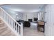 Bright living room with hardwood floors, fireplace, and staircase at 159 Finley Forest Dr, Chapel Hill, NC 27517
