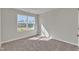 Bright bedroom featuring a large window, neutral walls, and plush carpet at 1723 Starlit Sky Ln, Cary, NC 27519