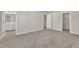 View of unfurnished bedroom with carpeted floor and view into bath and walk-in closet at 1723 Starlit Sky Ln, Cary, NC 27519