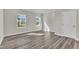 Bedroom with neutral walls, wood floors, and large windows that fill the room with sunlight at 1723 Starlit Sky Ln, Cary, NC 27519