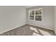 Unfurnished bedroom with carpeted floor and window view of trees and landscape at 1723 Starlit Sky Ln, Cary, NC 27519