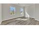 Bedroom with neutral walls, wood floors, and large windows that fill the room with sunlight at 1723 Starlit Sky Ln, Cary, NC 27519