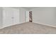 Carpeted bedroom featuring double closets and access to other areas of the home at 1723 Starlit Sky Ln, Cary, NC 27519