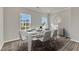Bright dining room features a white table set for six, complemented by natural light at 1723 Starlit Sky Ln, Cary, NC 27519