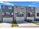 View of the townhome exteriors and attached garages at 1723 Starlit Sky Ln, Cary, NC 27519