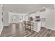 Charming kitchen with white cabinets, stainless appliances, and an island bar overlooking the living area at 1723 Starlit Sky Ln, Cary, NC 27519