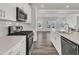 Modern kitchen featuring stainless steel appliances, white cabinetry, quartz countertop, and wood flooring at 1723 Starlit Sky Ln, Cary, NC 27519