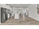 Open concept kitchen with stainless appliances flowing to a living area with a fireplace at 1723 Starlit Sky Ln, Cary, NC 27519