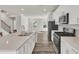 Bright open kitchen offering stainless steel appliances, quartz countertops, and access to the living area at 1723 Starlit Sky Ln, Cary, NC 27519