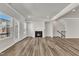 Bright living room featuring a fireplace, wood grain floors, and an access door to the outside at 1723 Starlit Sky Ln, Cary, NC 27519